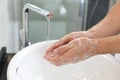 Man washing hands with soap over sink Royalty Free Stock Photo