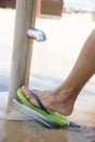 Man washing his feet on the beach Royalty Free Stock Photo