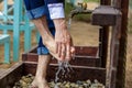 Man washing his feet on the sand beach. Royalty Free Stock Photo