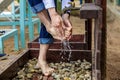 Man washing his feet on the sand beach. Royalty Free Stock Photo