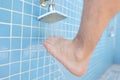 Man washing his feet from sand under shower on beach closeup Royalty Free Stock Photo