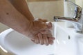 A man is washing his hands with antibacterial soap with running water Royalty Free Stock Photo