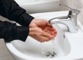 Man washing his hands in running water Royalty Free Stock Photo