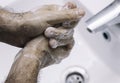 Man washing his hands with soap and water