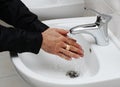 Man washing his hands under running water Royalty Free Stock Photo