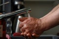 Man washing his hands under running water Royalty Free Stock Photo