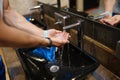 Man washing his hands under running water from tap in public toilet closeup Royalty Free Stock Photo