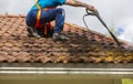 Man is washing the roof with a high pressure washer Royalty Free Stock Photo