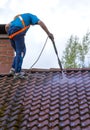 Man is washing the roof with a high pressure washer Royalty Free Stock Photo