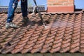 Man is washing the roof with a high pressure washer Royalty Free Stock Photo