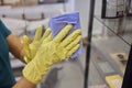 Man washing window in protective gloves closeup. Cleaning of apartments concept.