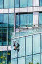 Man washing windows on a glass skyscraper