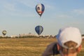 Man Watching At Air-Balloons Participating in International Aerostatics Cup Royalty Free Stock Photo