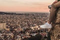 Man on the top of a mountain watching the city