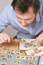 Man watching a collection of postage stamps Royalty Free Stock Photo