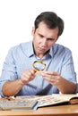 Man watching a collection of postage stamps Royalty Free Stock Photo