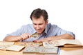 Man watching a collection of postage stamps with magnifier Royalty Free Stock Photo