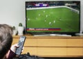 Man watching a football game on TV