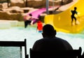 Man watching at kids playing in pool Royalty Free Stock Photo