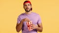 man watching movie and reaching popcorn