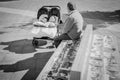 Man watching over two babies in a buggy in Algeciras, Spain. Royalty Free Stock Photo