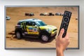 Man is watching paris dakar racing on TV Royalty Free Stock Photo