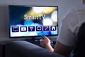 Man watching smart tv. Choosing movie or series from the menu. Royalty Free Stock Photo