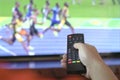 Man watching sports track and field on tv