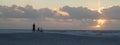 Man watching sunset at the beach with bicycle