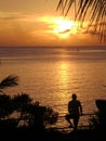 Man watching the sunset at the Taga Beach, Tinian