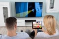 Man Watching The Television With Her Wife Using Tablet Royalty Free Stock Photo