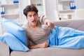 The man watching tv from bed holding remote control unit Royalty Free Stock Photo