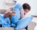 Man watching tv from bed holding remote control unit Royalty Free Stock Photo