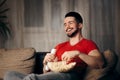 Man Watching TV While Snacking on Pop Corn