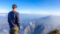 A man watching the volcanic landscape in front of him