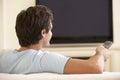 Man Watching Widescreen TV At Home