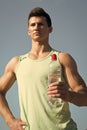 Man with water bottle in muscular hands