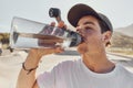 Man, water bottle and outdoor closeup for hydration, fitness and workout in summer sunshine. Guy, drinking and water for Royalty Free Stock Photo