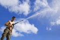 Man with water hose Royalty Free Stock Photo