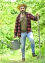 Man with watering can and shovel. gardening and watering plants. agriculture and tough work concept. Gardening or