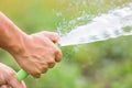 Man watering the garden from hose Royalty Free Stock Photo