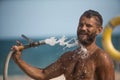 Man watering with hose Royalty Free Stock Photo