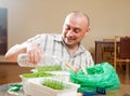 Man watering parsley and dill Royalty Free Stock Photo