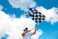 Man waving a checkered flag on a raceway