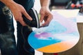 Man is waxing a snowboard