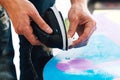 Man is waxing a snowboard