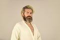 Man wear bathrobe at the bathroom. handsome man in the morning. bearded guy in white terry bathrobe sleeping in hotel Royalty Free Stock Photo