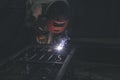 Man wear glove and goggles working with arc welding machine to weld steel at outdoor.