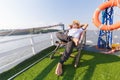 Man wear hat and sunglasses. He lie on sunbeds in the cruise ship Royalty Free Stock Photo