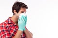 Man wear protective face mask and medical glove for preventing spread coronavirus to other people. Handsome young guy coughing in Royalty Free Stock Photo